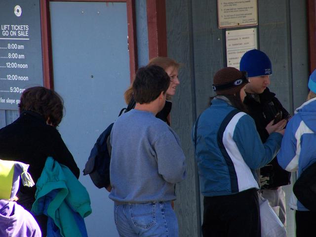 Dad Standing In Line Buying The Lift Tickets.