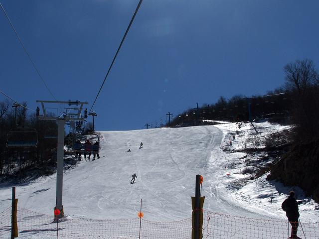 Going Up The Quad Lift. Looking Up White Lighting.