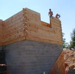 Workers Putting Logs Up In Kitchen