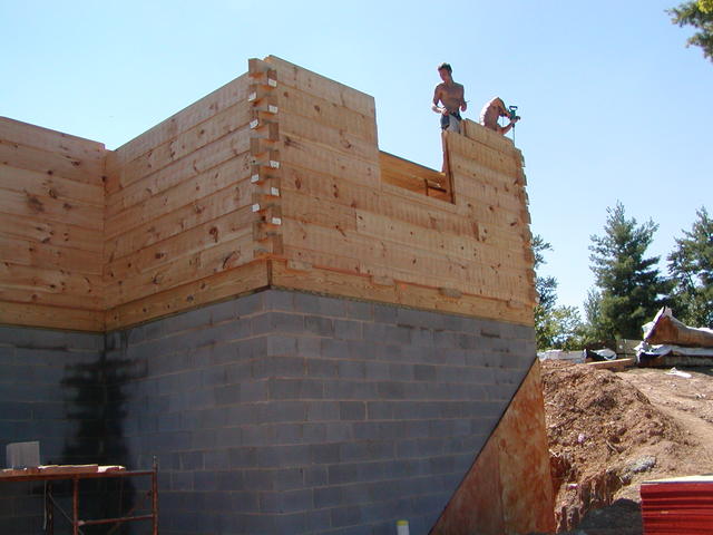 Workers Putting Logs Up In Kitchen