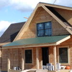 Front View As Roofers Are Putting On The Tin Roof