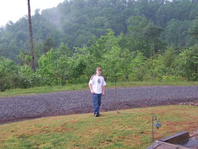 Brandon Standing In Front Yard At Cabin