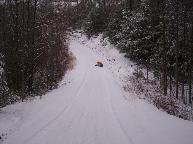 Sleding Down Road Beside House